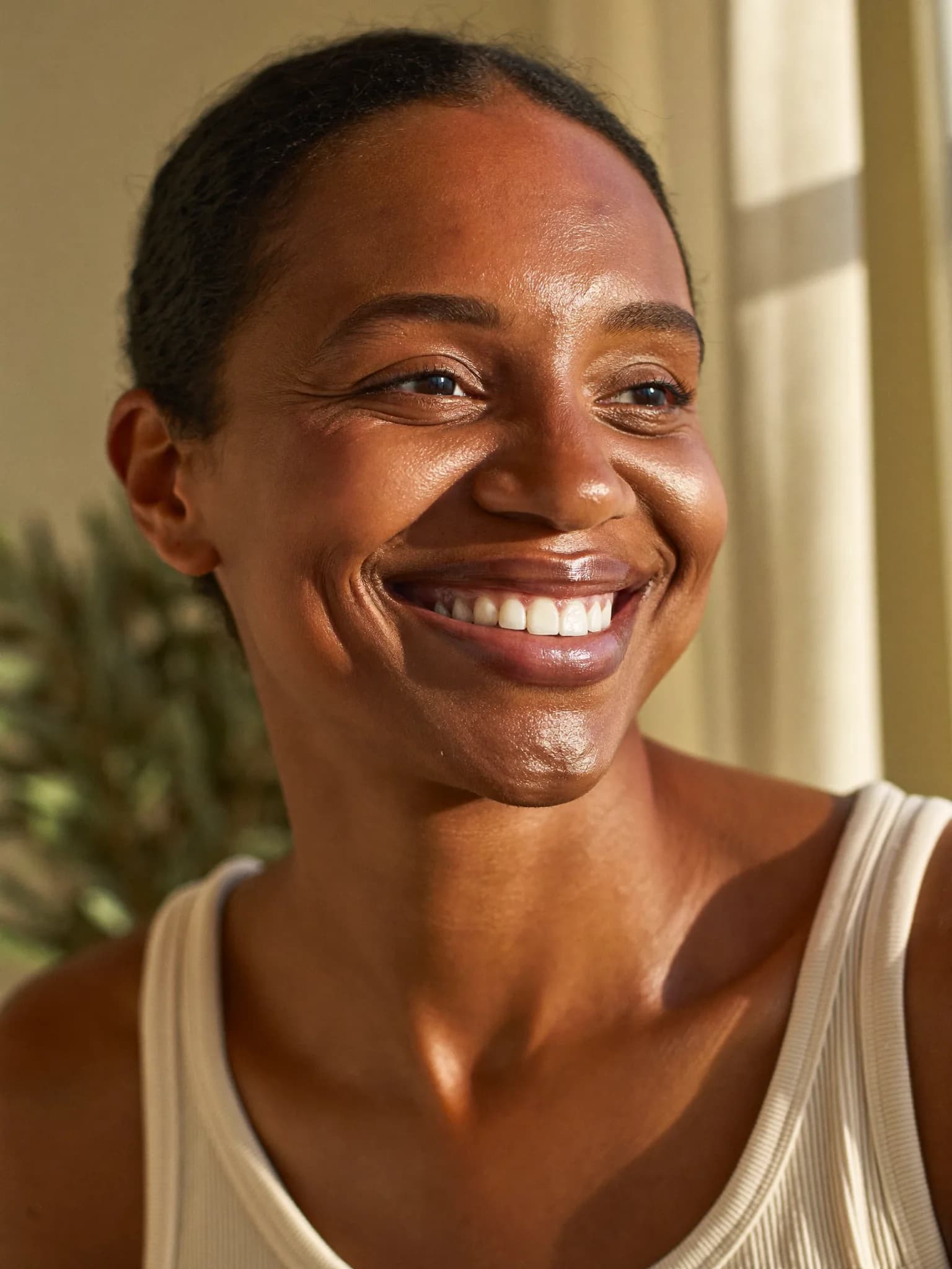 A person in soft natural light, reflecting the quiet confidence of a medically supervised hair and skin program.