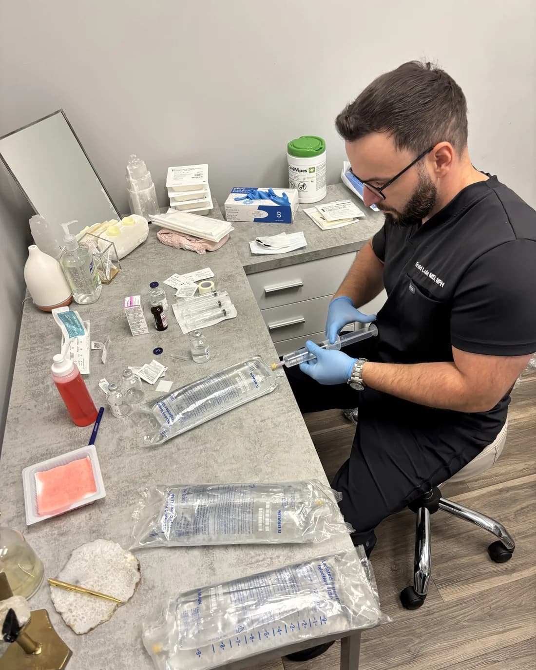 Dr. Erald Lula preparing IV bags at the NuHealth Royal Oak clinic