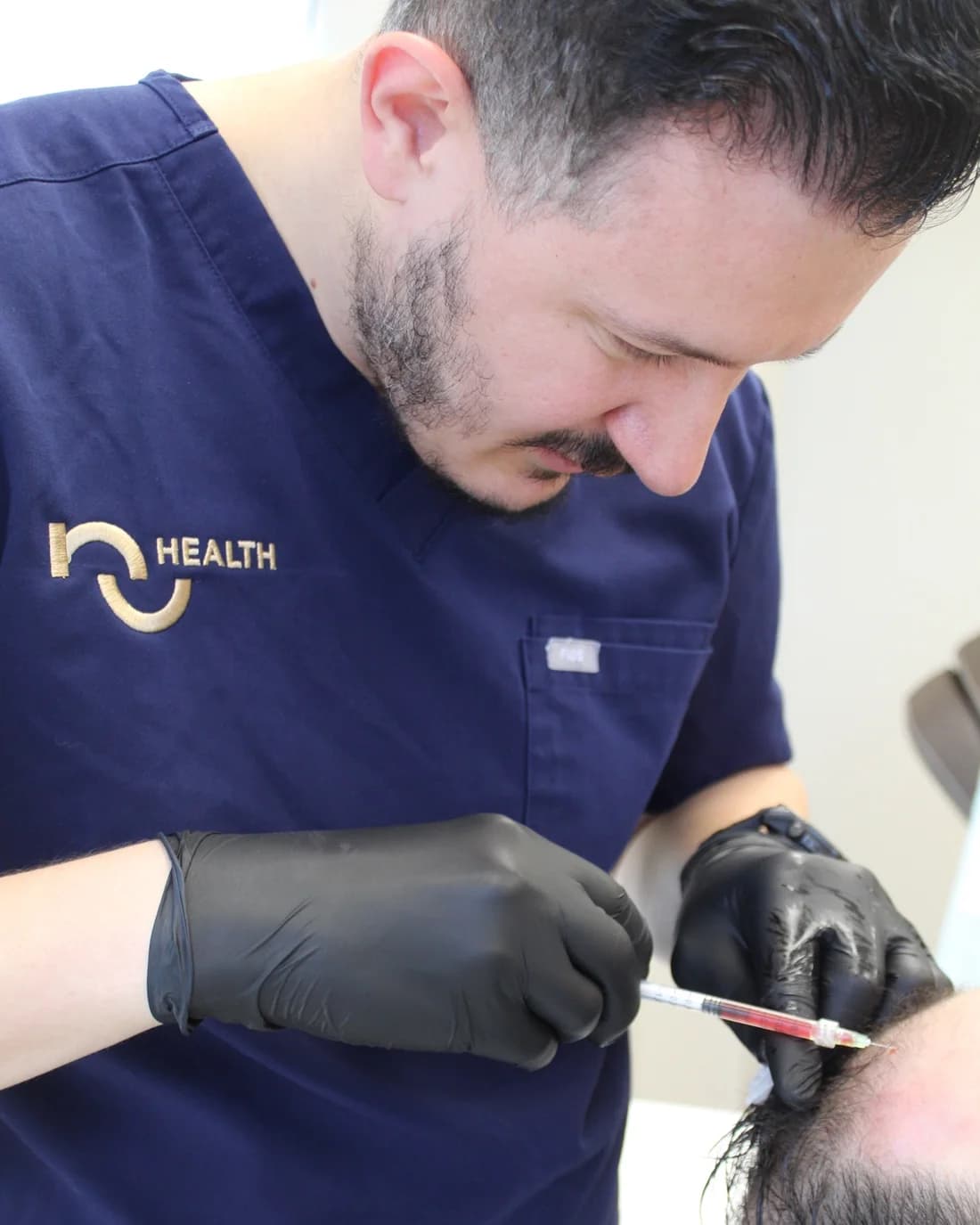 Kris Cutaj, MSPAS, PA-C, FAACM, performing a PRP scalp treatment at the NuHealth clinic in Royal Oak