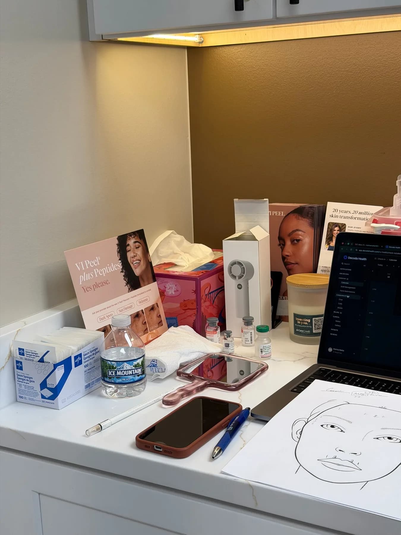 A face-mapping chart and treatment notes laid out on the counter of a NuHealth treatment room before a consult