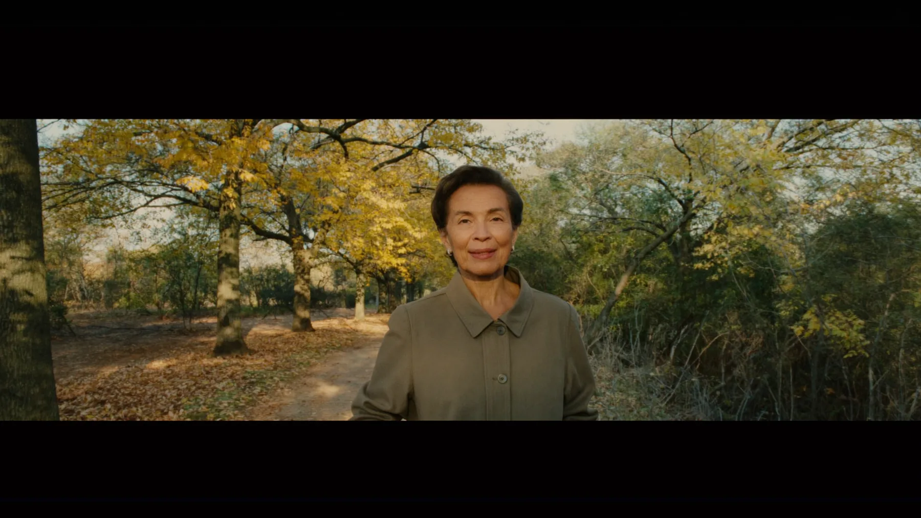 A woman on a brisk morning walk in warm light, clear-eyed and energetic — the steady vitality balanced hormones support